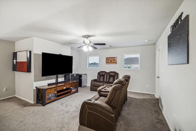 carpeted living area featuring a ceiling fan and baseboards