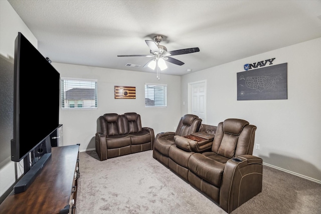 cinema with baseboards, carpet, visible vents, and a ceiling fan