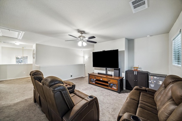 carpeted living area with attic access, visible vents, baseboards, ceiling fan, and a textured ceiling