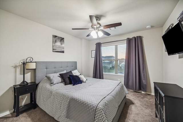 carpeted bedroom featuring visible vents, a ceiling fan, and baseboards