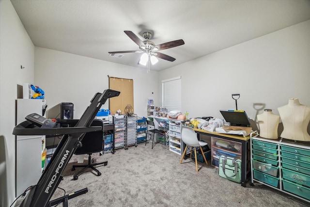 carpeted office with visible vents and a ceiling fan