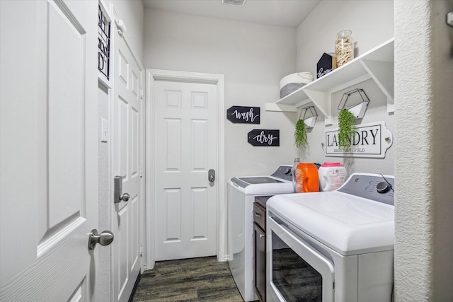 laundry room with washer and dryer, laundry area, and dark wood finished floors