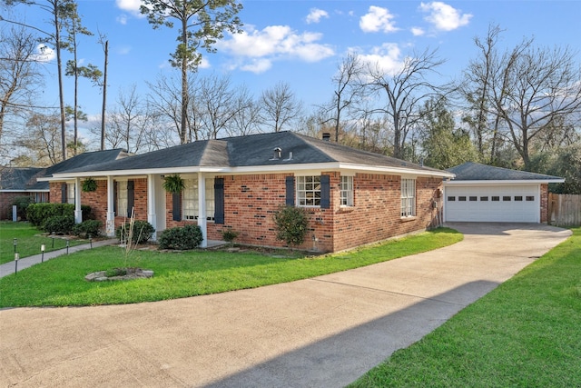 ranch-style house with brick siding, concrete driveway, a front yard, fence, and an outdoor structure