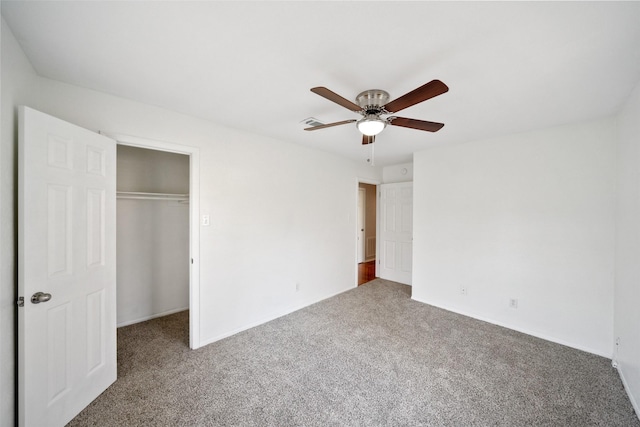 unfurnished bedroom featuring ceiling fan, carpet floors, a closet, and visible vents