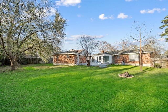 view of yard with an outdoor fire pit and fence