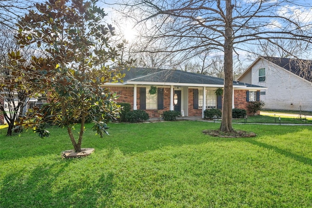 view of front of house with brick siding and a front lawn