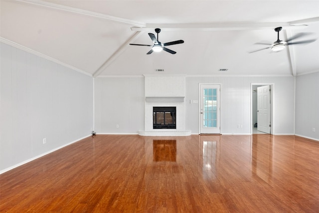 unfurnished living room featuring a ceiling fan, visible vents, a fireplace, and wood finished floors