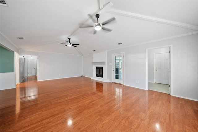 unfurnished living room with vaulted ceiling with beams, ceiling fan, a fireplace, wood finished floors, and visible vents