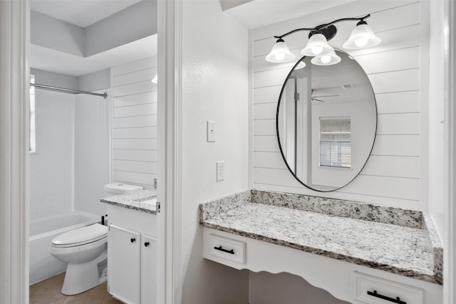 bathroom featuring toilet, a ceiling fan, vanity, tub / shower combination, and tile patterned floors