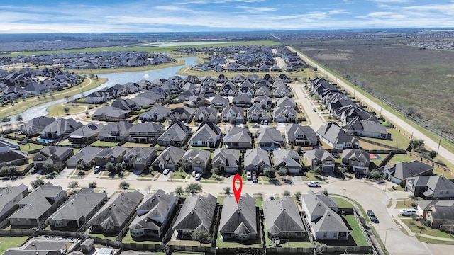 birds eye view of property featuring a water view and a residential view