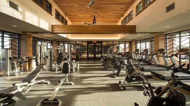 exercise room featuring a high ceiling and visible vents