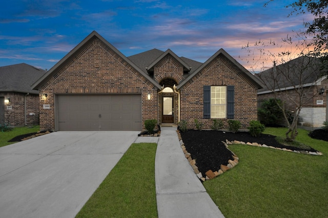 view of front of home with brick siding, roof with shingles, concrete driveway, an attached garage, and a front lawn