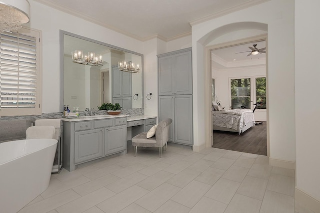 ensuite bathroom with crown molding, a soaking tub, a ceiling fan, connected bathroom, and vanity