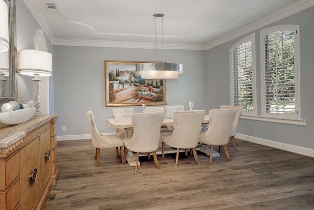 dining space with visible vents, crown molding, baseboards, and wood finished floors