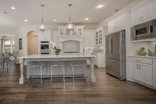 kitchen featuring stainless steel appliances, light countertops, visible vents, and white cabinetry