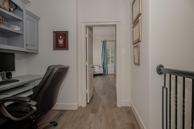 home office featuring light wood-type flooring and baseboards