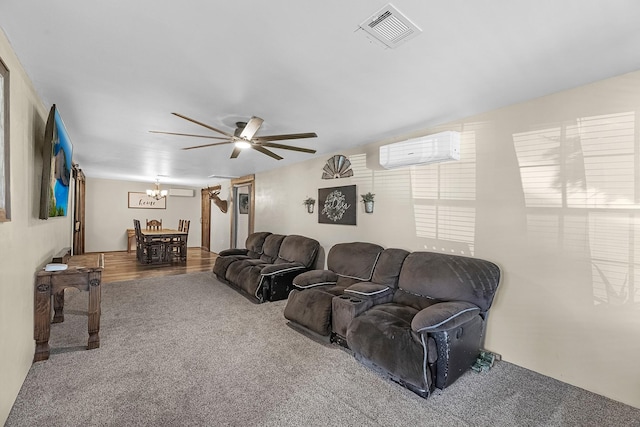 living area with visible vents, ceiling fan with notable chandelier, an AC wall unit, and carpet floors