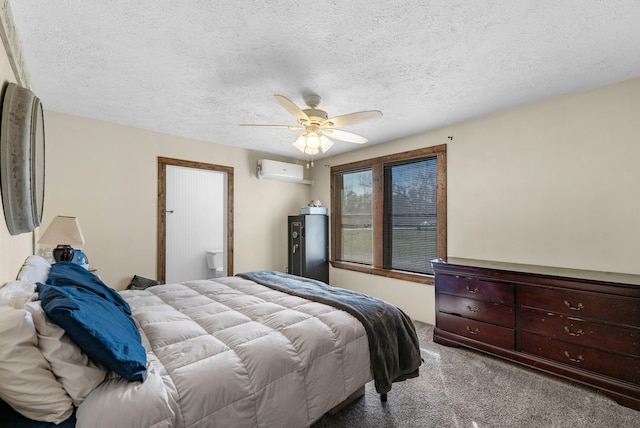 carpeted bedroom featuring a textured ceiling, an AC wall unit, and a ceiling fan