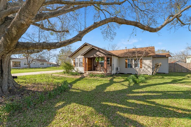 view of front of property with a front lawn and fence