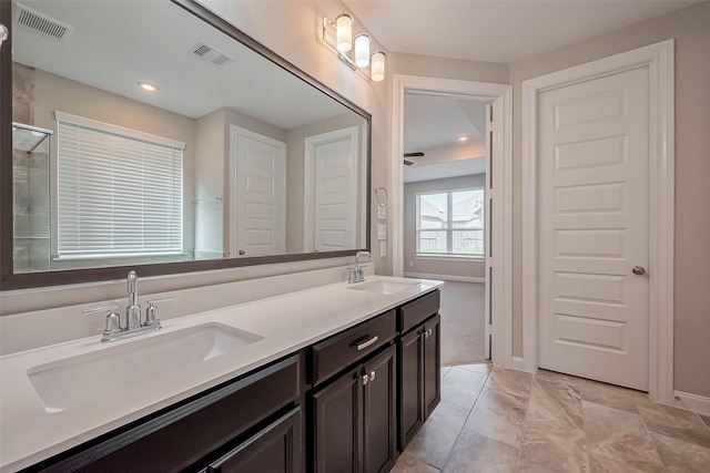 bathroom featuring visible vents, a sink, and double vanity