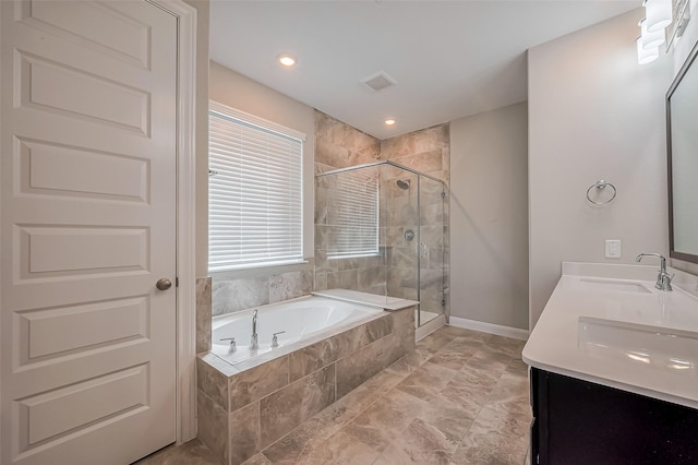 full bathroom featuring double vanity, a stall shower, visible vents, a garden tub, and a sink