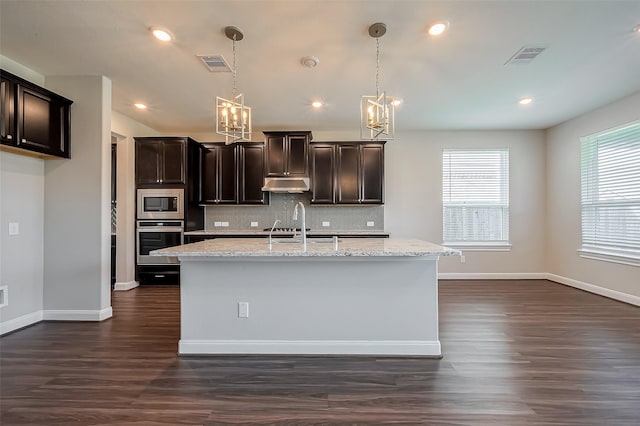 kitchen with visible vents, dark wood-type flooring, tasteful backsplash, appliances with stainless steel finishes, and an inviting chandelier