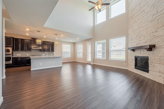 unfurnished living room featuring dark wood-style floors and a wealth of natural light