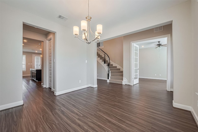 spare room with stairway, baseboards, visible vents, and dark wood-type flooring