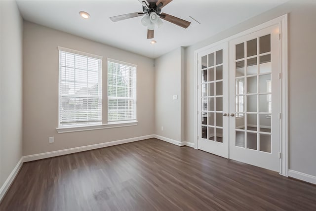 empty room with french doors, dark wood finished floors, and baseboards