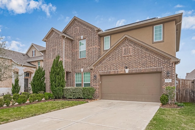 view of front of home with brick siding, fence, concrete driveway, stucco siding, and an attached garage