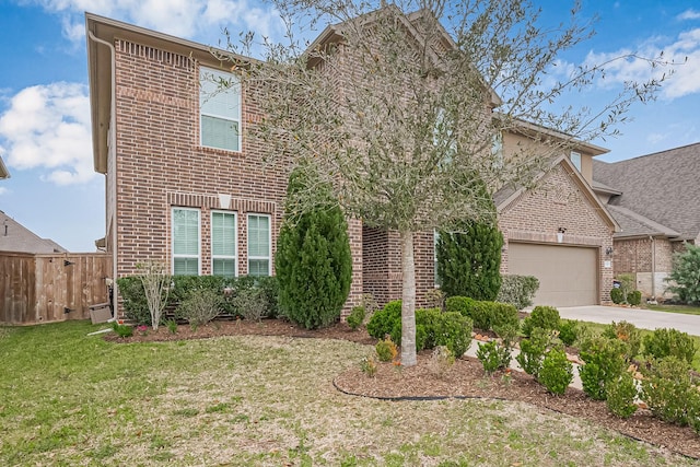 traditional-style home with a front yard, fence, driveway, a garage, and brick siding