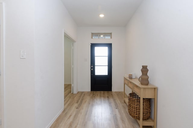 entryway featuring baseboards and light wood finished floors