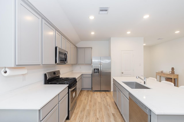 kitchen featuring visible vents, gray cabinets, a sink, recessed lighting, and stainless steel appliances