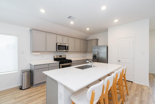 kitchen featuring a sink, appliances with stainless steel finishes, and gray cabinetry