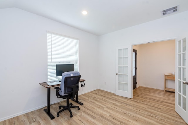 office with visible vents, french doors, light wood-type flooring, and baseboards