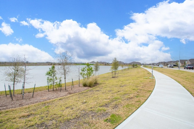 exterior space featuring a yard and a water view