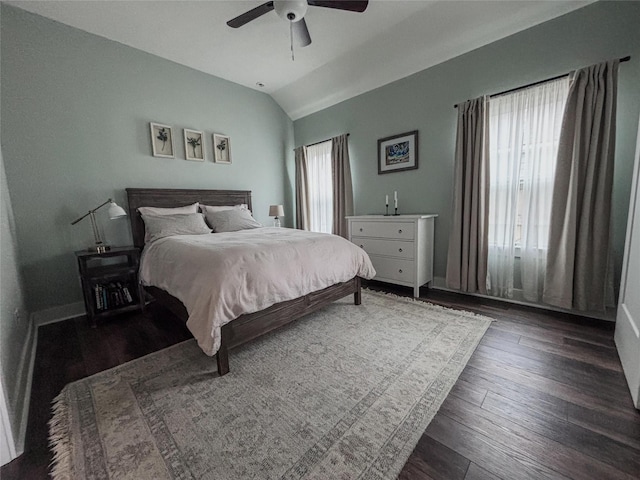 bedroom featuring lofted ceiling, ceiling fan, multiple windows, and wood finished floors