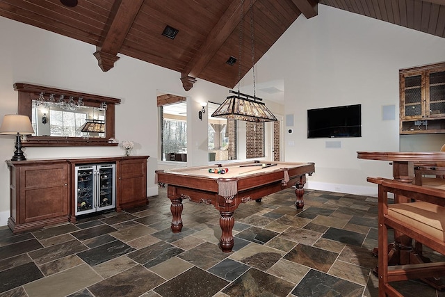 playroom featuring beam ceiling, high vaulted ceiling, beverage cooler, baseboards, and a dry bar