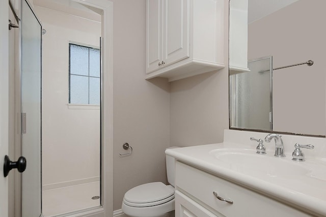 bathroom with toilet, a stall shower, and vanity