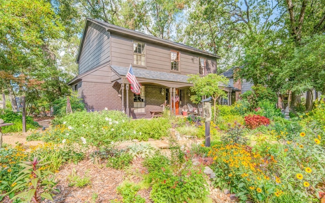 view of front of house featuring a porch and brick siding