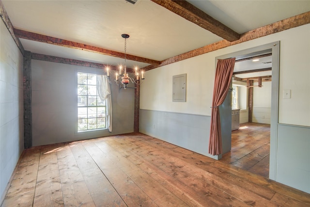 unfurnished dining area featuring wood-type flooring, electric panel, a chandelier, and beam ceiling