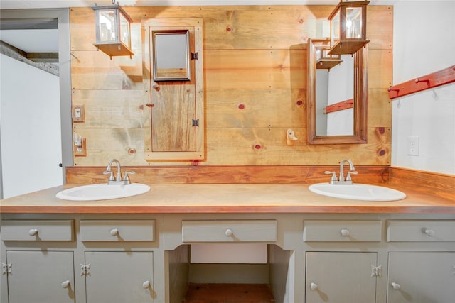 bathroom featuring a sink and double vanity