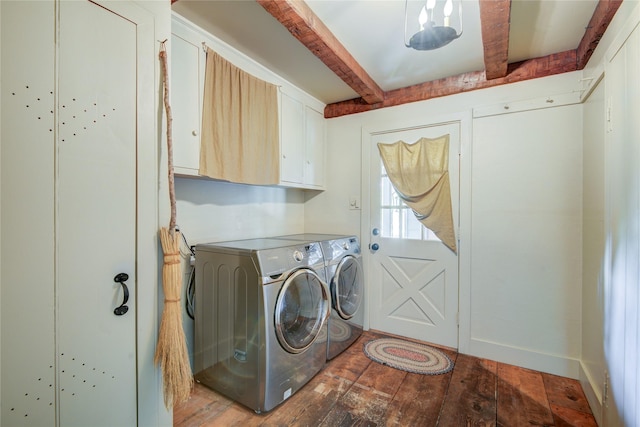 laundry room featuring hardwood / wood-style floors, cabinet space, and washing machine and clothes dryer
