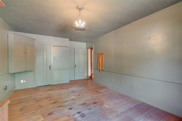 unfurnished bedroom featuring baseboards and light wood-style floors