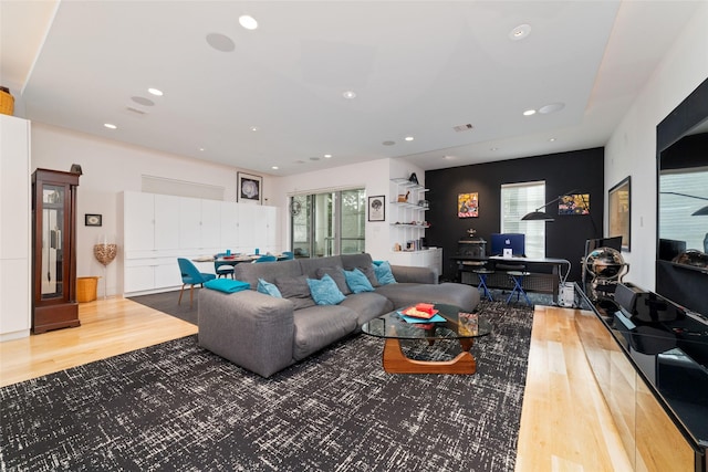 living area with plenty of natural light, wood finished floors, and recessed lighting