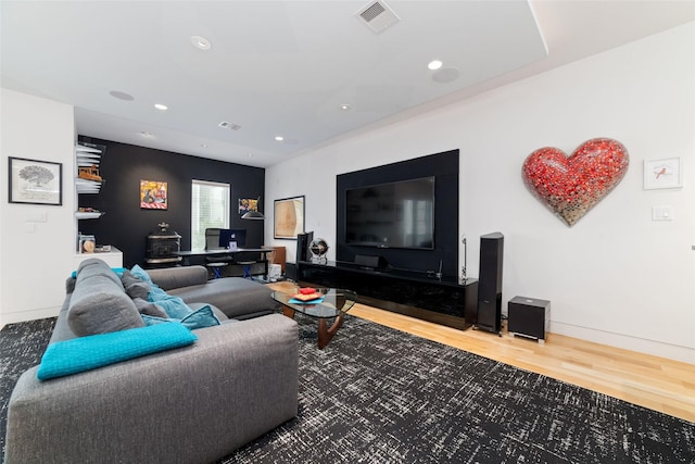 living area featuring baseboards, wood finished floors, visible vents, and recessed lighting