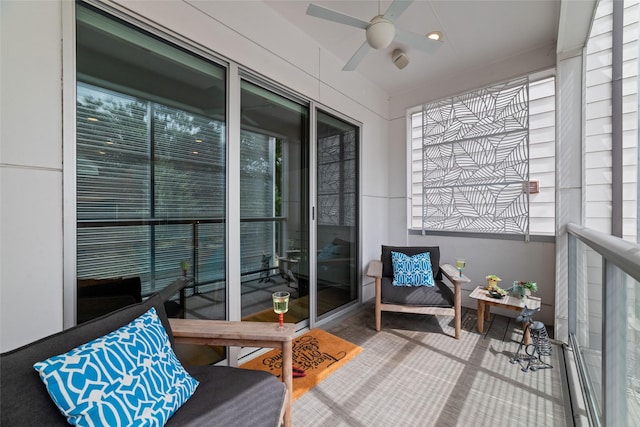 sunroom / solarium with a healthy amount of sunlight and ceiling fan