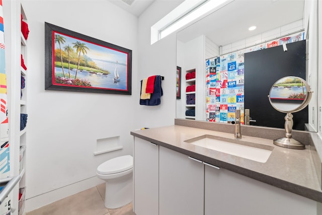 bathroom featuring tile patterned flooring, a shower with curtain, vanity, and toilet