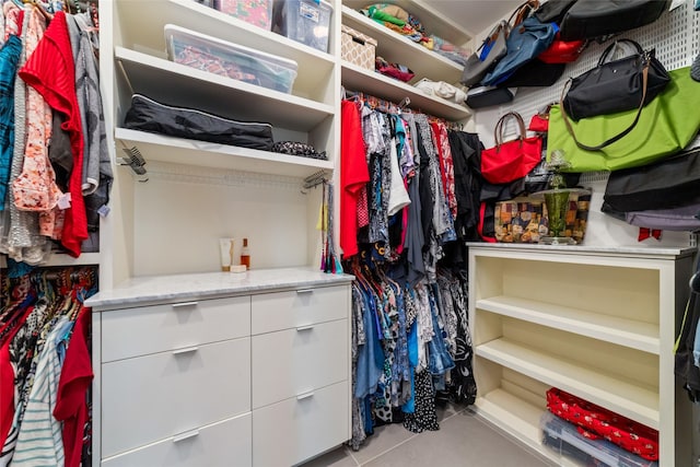 spacious closet with light tile patterned floors