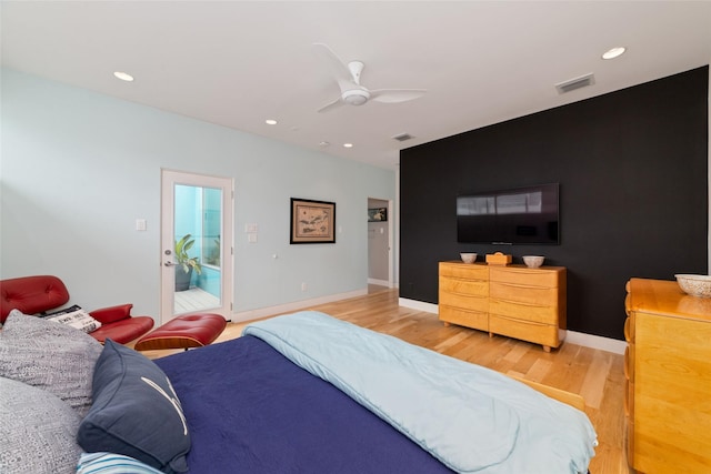 bedroom featuring light wood finished floors, ceiling fan, visible vents, and baseboards